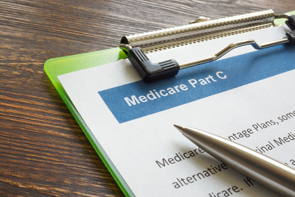 Medicare Part C Insurance Papers With Clipboard and Pen